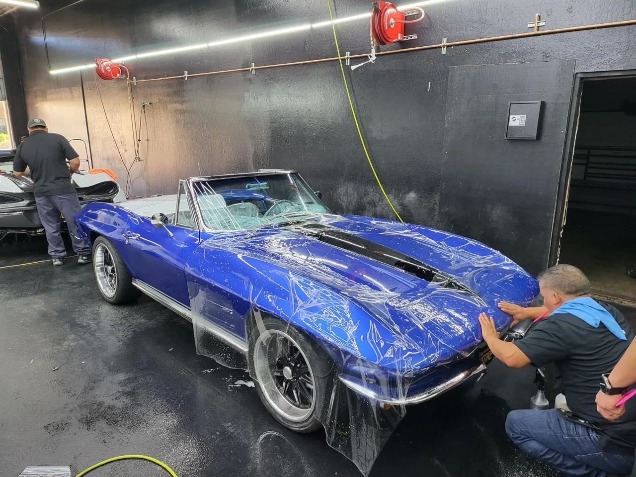Blue classic Corvette Stingray with film being installed