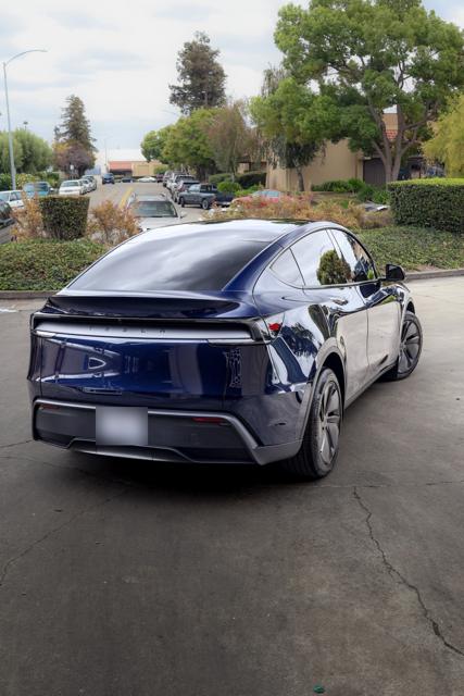 Dark blue Tesla Model Y rear view with tinted glass outside 68 Auto Film
