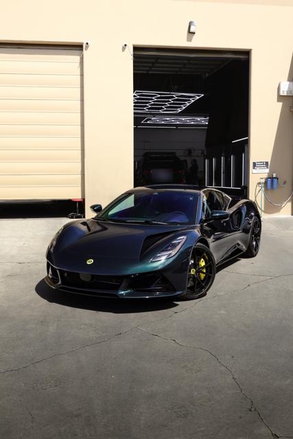 Dark green color-shift Lotus Emira outside 68 Auto Film in Milpitas