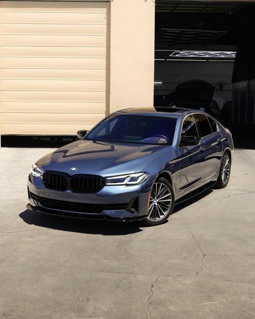 Grey-blue BMW 5 Series with tinted glass outside 68 Auto Film