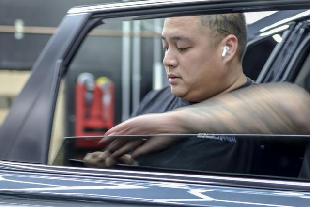 Installer working on a door window at 68 Auto Film