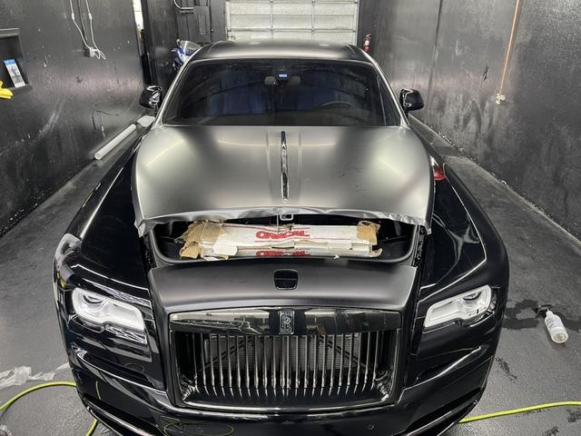 Rolls-Royce Wraith with film being applied to the hood
